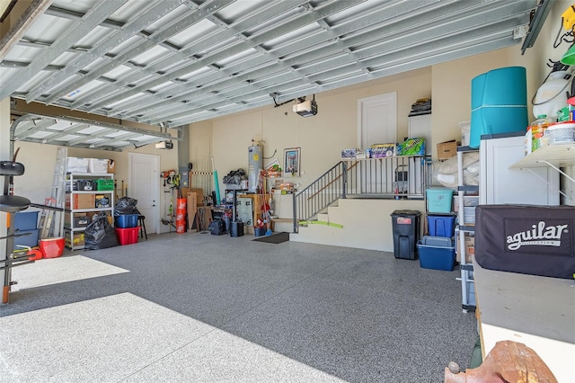 garage with water heater and a garage door opener