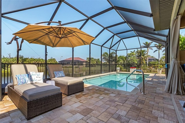 view of pool with a patio area, glass enclosure, and a fenced in pool