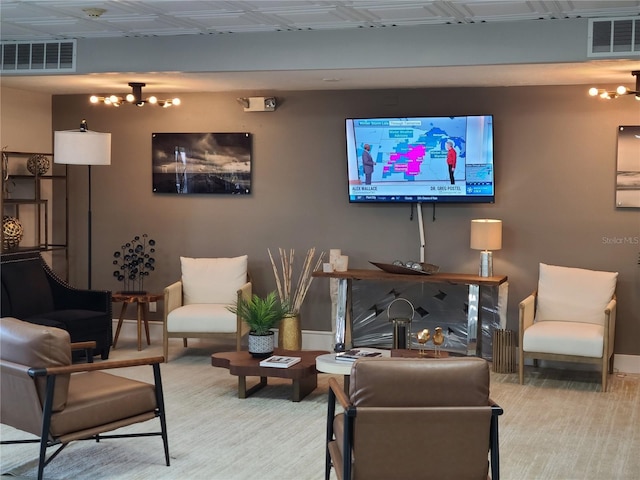 living room featuring baseboards, visible vents, and a chandelier