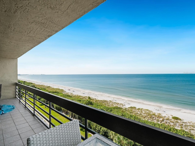 balcony with a beach view and a water view