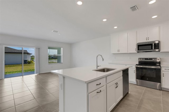 kitchen with visible vents, appliances with stainless steel finishes, light countertops, and a sink