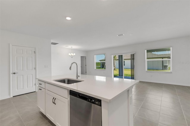 kitchen featuring open floor plan, dishwasher, a sink, and light tile patterned floors