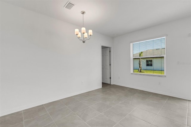 spare room with a chandelier, visible vents, baseboards, and light tile patterned flooring