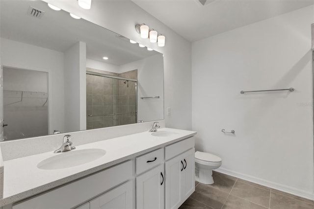 bathroom with a stall shower, visible vents, a sink, and tile patterned floors