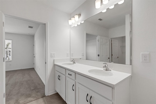 bathroom featuring visible vents, a sink, and double vanity