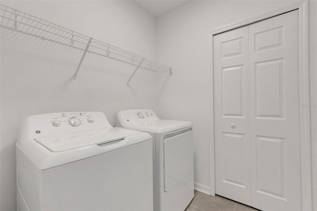 laundry area featuring light tile patterned floors, laundry area, and independent washer and dryer