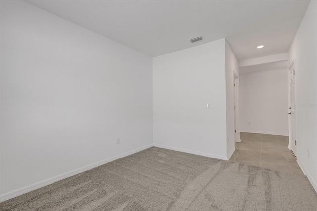 tiled spare room with carpet floors, recessed lighting, visible vents, and baseboards