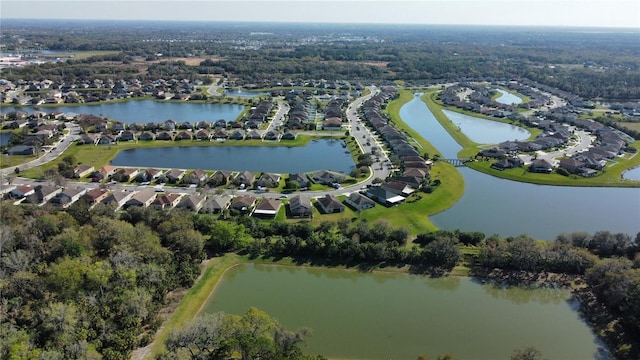 drone / aerial view featuring a water view and a residential view