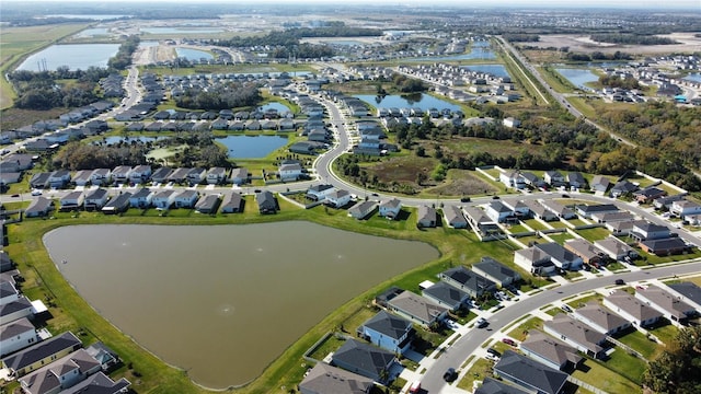 birds eye view of property featuring a water view and a residential view