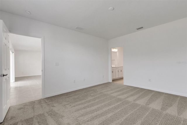 unfurnished room with light colored carpet, visible vents, and baseboards