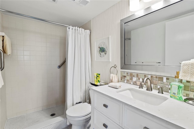 bathroom featuring toilet, a shower stall, tasteful backsplash, and vanity