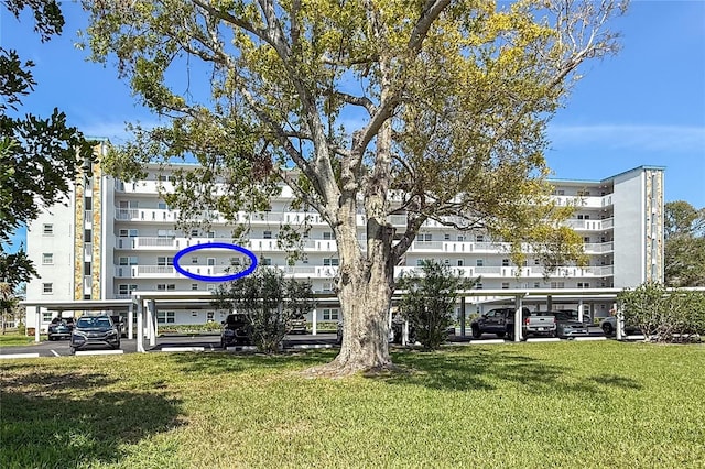 view of property featuring covered parking