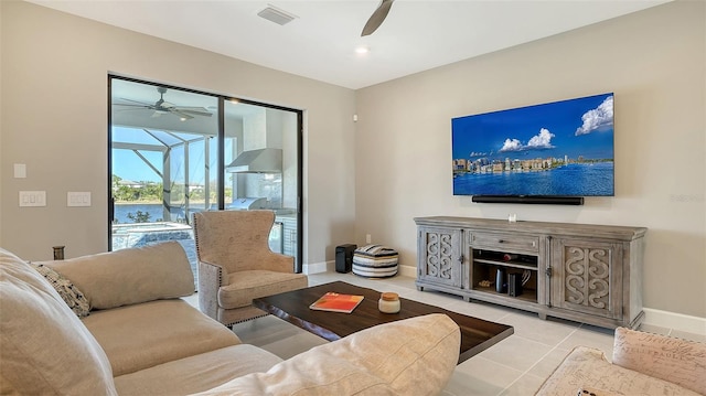 living area featuring a sunroom, visible vents, ceiling fan, and baseboards