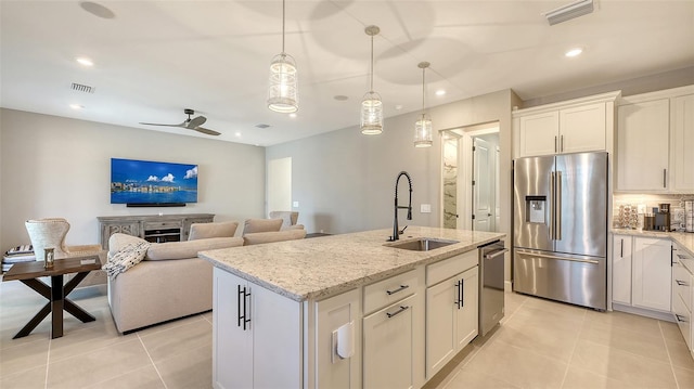 kitchen featuring visible vents, stainless steel appliances, a sink, and light tile patterned flooring