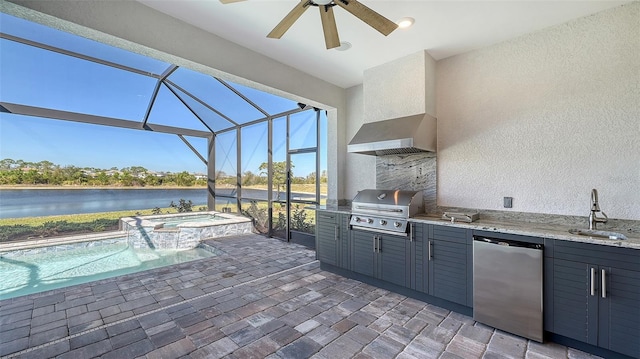 view of patio with an outdoor kitchen, area for grilling, glass enclosure, ceiling fan, and a sink