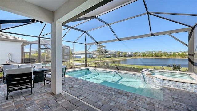 view of swimming pool featuring a patio area, a water view, a pool with connected hot tub, and a lanai