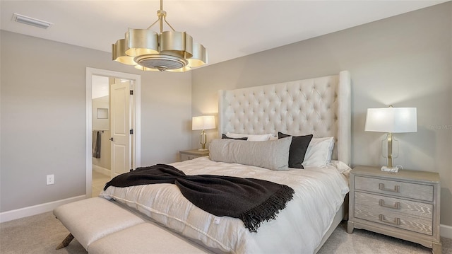 bedroom with visible vents, ensuite bath, light carpet, and baseboards