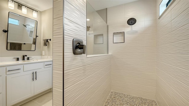 bathroom with walk in shower and vanity