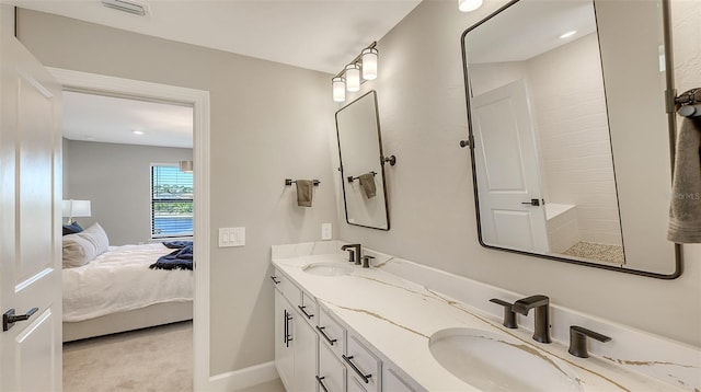 ensuite bathroom featuring visible vents, a sink, ensuite bath, and double vanity