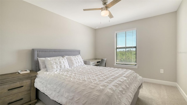 carpeted bedroom with a ceiling fan and baseboards