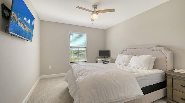 carpeted bedroom featuring a ceiling fan and baseboards