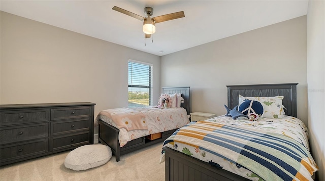 bedroom featuring light colored carpet and ceiling fan