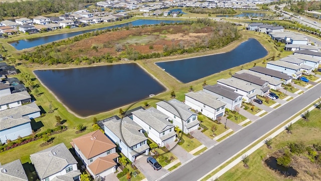 drone / aerial view with a water view and a residential view