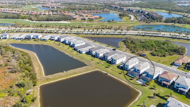 birds eye view of property with a water view and a residential view