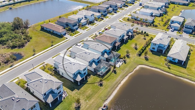 birds eye view of property featuring a water view and a residential view