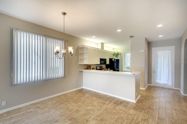 kitchen featuring a textured ceiling, open shelves, baseboards, light wood-type flooring, and black appliances