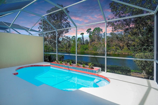 view of swimming pool featuring a water view, a lanai, and a patio