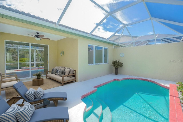 view of pool featuring ceiling fan, glass enclosure, a patio, and outdoor lounge area