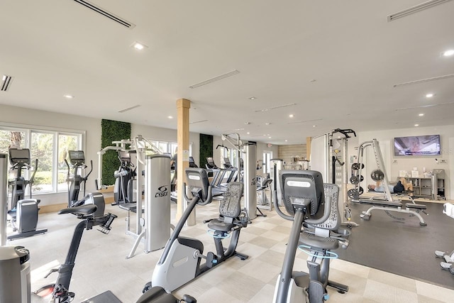 workout area with ornate columns, visible vents, and recessed lighting