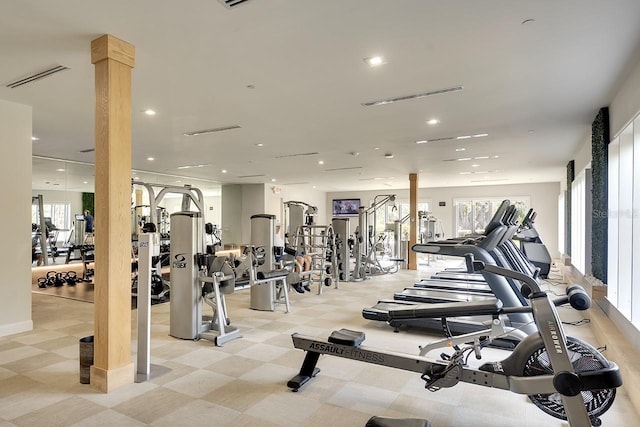 workout area with ornate columns, visible vents, a wealth of natural light, and recessed lighting