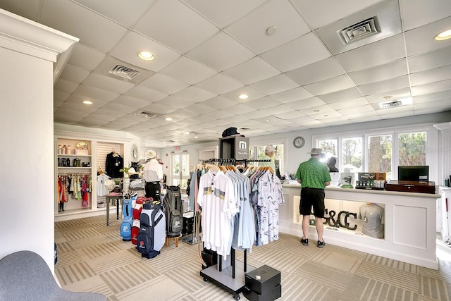 exercise room featuring carpet flooring, visible vents, and a drop ceiling