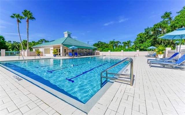 pool with fence and a patio