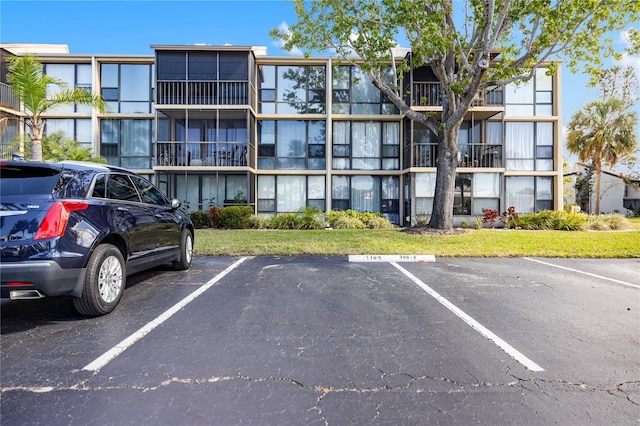 view of building exterior featuring uncovered parking