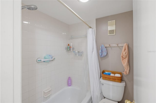 bathroom featuring toilet, visible vents, and shower / bath combo with shower curtain