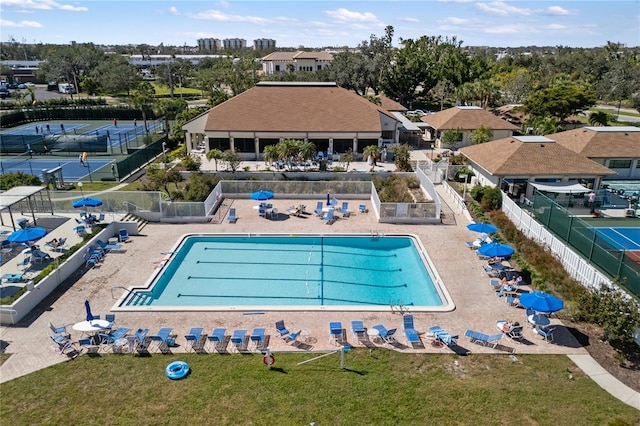 view of swimming pool featuring a patio and fence