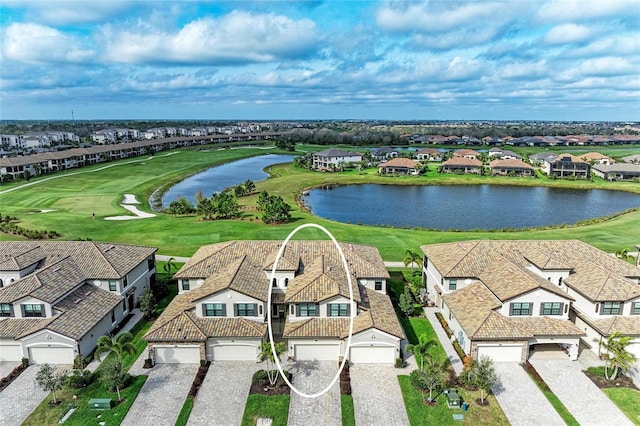 drone / aerial view with a residential view, a water view, and golf course view