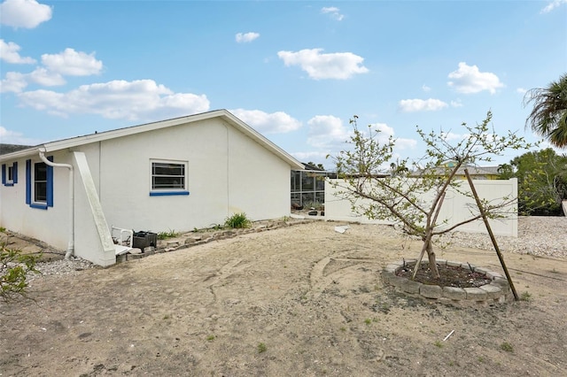 view of side of property with stucco siding