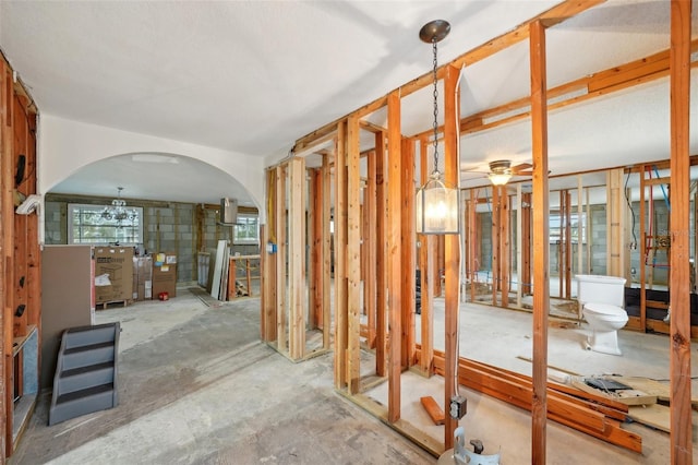 misc room with a ceiling fan and arched walkways