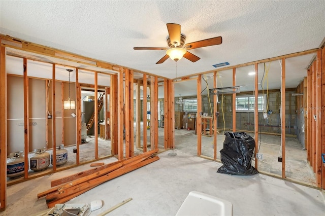 miscellaneous room featuring a textured ceiling, visible vents, and a ceiling fan