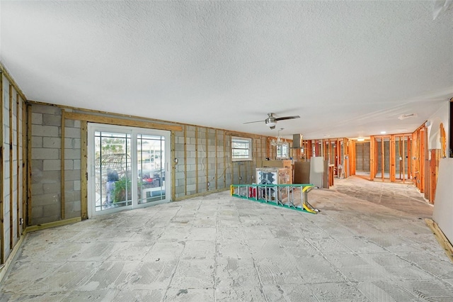 unfurnished living room featuring a textured ceiling and a ceiling fan