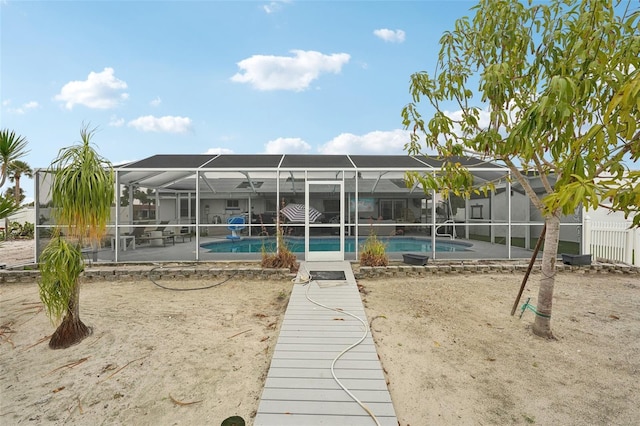 back of house with a patio, a lanai, fence, and an outdoor pool