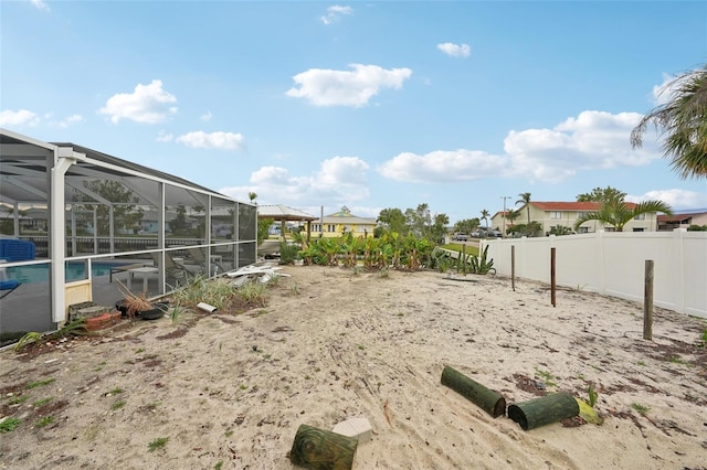 view of yard featuring a lanai, fence, and a fenced in pool