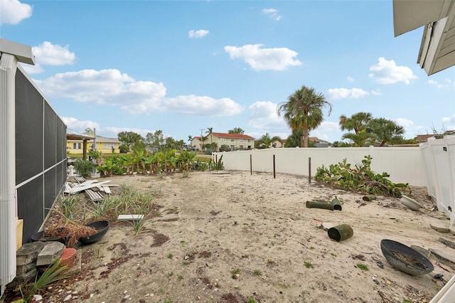 view of yard with a lanai and a fenced backyard