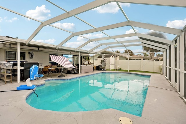 view of swimming pool featuring a patio, a lanai, fence, a fenced in pool, and outdoor dining space