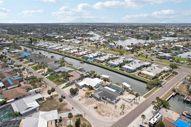 bird's eye view featuring a water view and a residential view