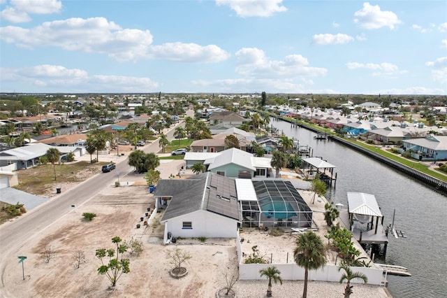 drone / aerial view with a water view and a residential view